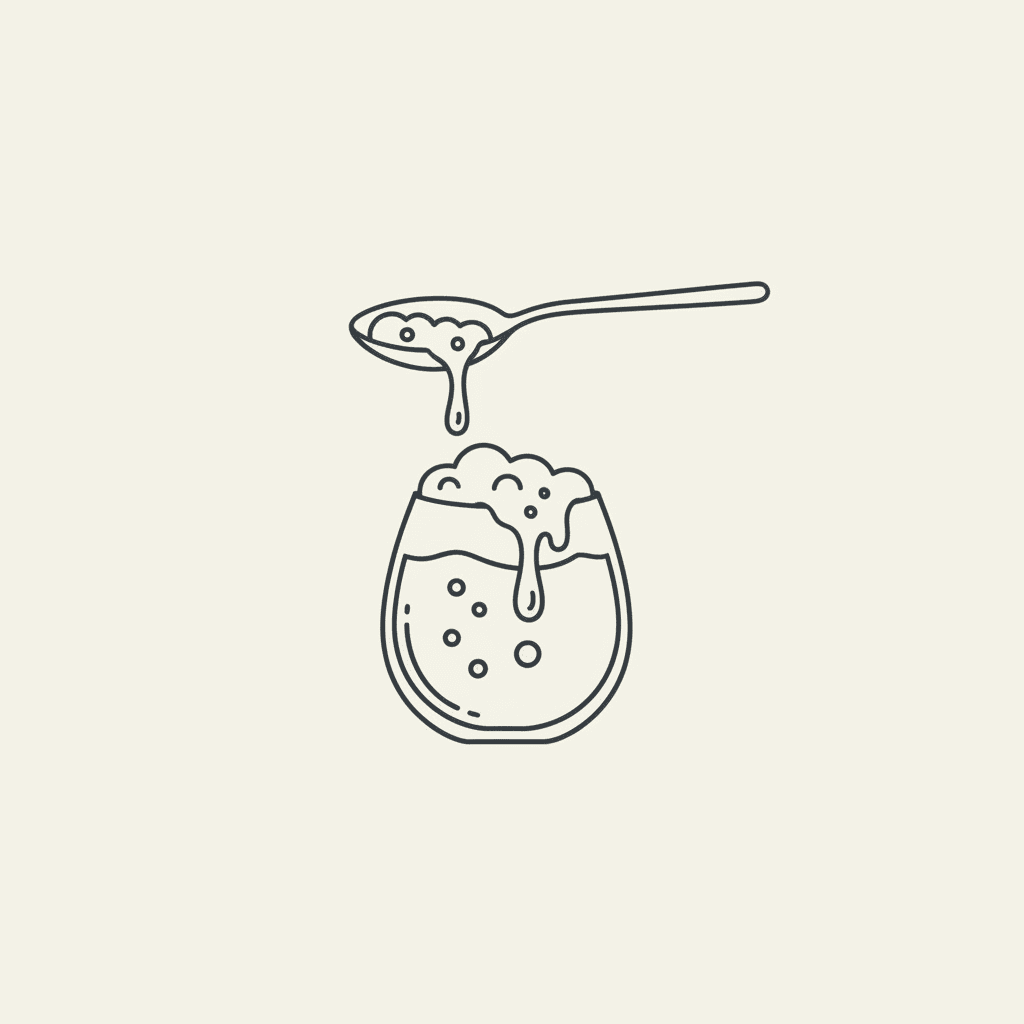 Layer the Foam: a spoon hovering over a full glass, with foam being poured over it