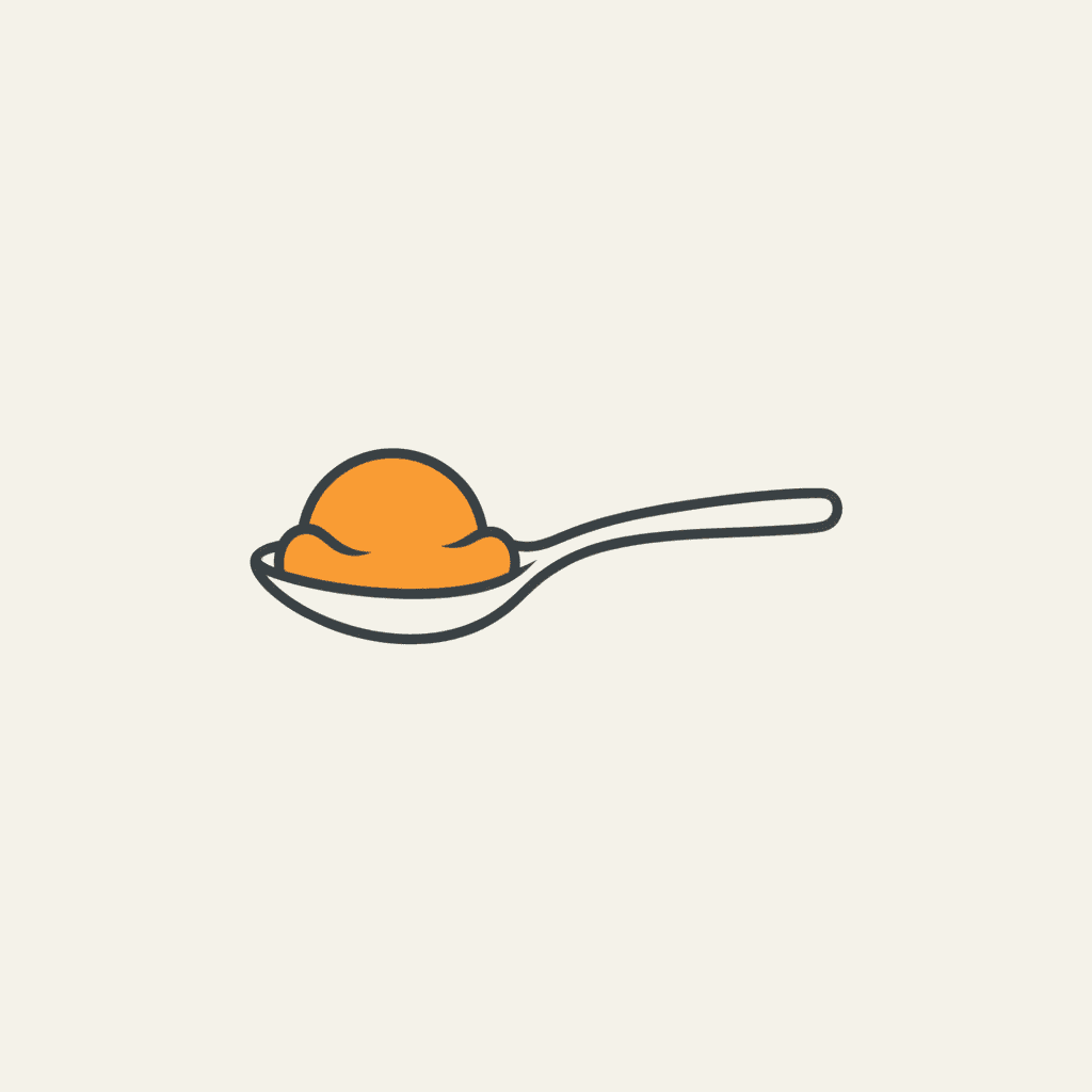Achieve Soft-Serve Texture: a spoon holding a scoop of creamy orange mango puree