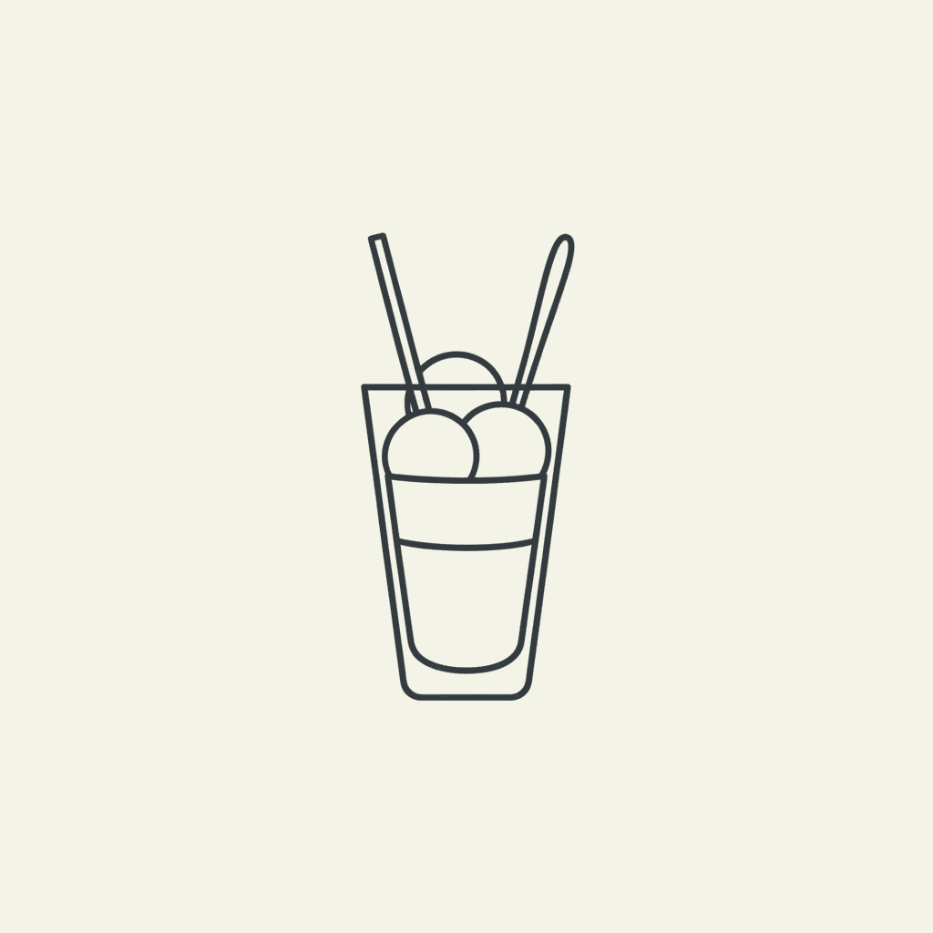 Serve Immediately: a tall glass of finished float with a straw and spoon, showing distinct layers